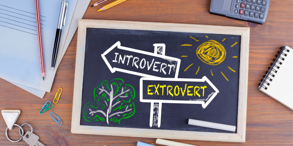Chalkboard on desk with introvert and extrovert signs