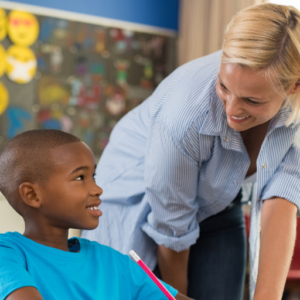 Substitute smiles at student in classroom